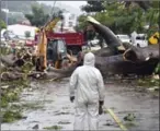  ?? RODRIGO ARANGUA/AFP ?? Workers cut a tree that killed a boy when it fell during a storm in Panama City on Tuesday.