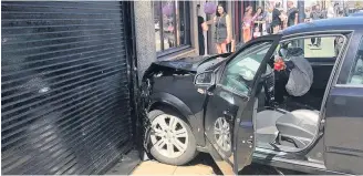  ??  ?? Wrecked The vehicle was left a crumpled mess after smashing into a shop front on Union Street