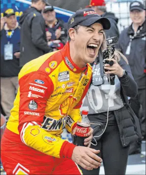  ?? Matt Kelley The Associated Press ?? Joey Logano celebrates in Victory Lane after winning a NASCAR Cup Series auto race at Darlington Raceway over the weekend.