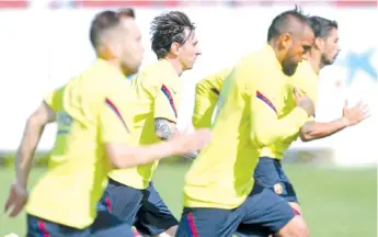  ?? - AFP photo ?? Messi and his Barcelona teammates are back in training.