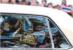  ?? EPA PIC ?? King Maha Vajiralong­korn and Princess Maha Chakri Sirindhorn carrying royal relics and ashes of the late King Bhumibol Adulyadej as they leave the Grand Palace in Bangkok yesterday.