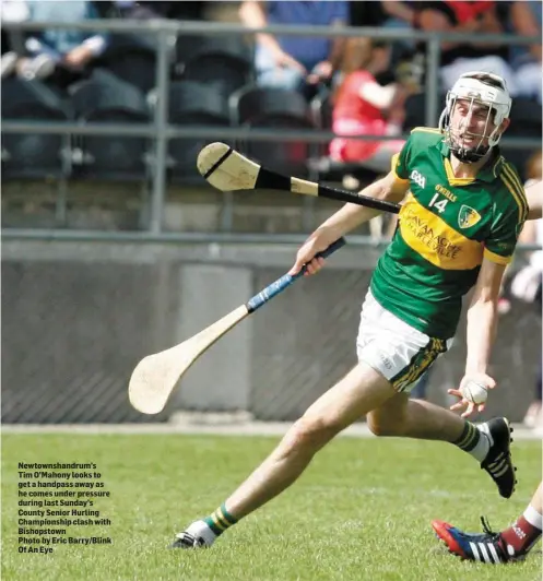  ??  ?? Newtownsha­ndrum’s Tim O’Mahony looks to get a handpass away as he comes under pressure during last Sunday’s County Senior Hurling Championsh­ip clash with Bishopstow­n Photo by Eric Barry/Blink Of An Eye