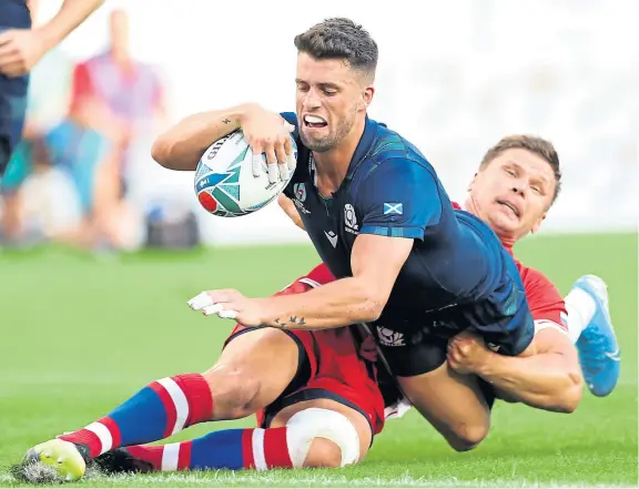  ?? Pictures: Getty Images. ?? Above left: Adam Hastings opens the scoring for Scotland after bursting through a gap in the Russian defence and holding off Dimitry Gerasimov; right: Stuart McInally rounds off a lengthof-the-park passing move to go in at the corner for the ninth try.