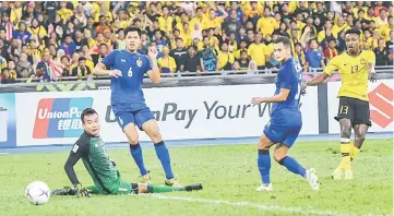  ??  ?? Malaysia’s Mohamadou Sumareh (right) shoots at goal during the AFF Suzuki Cup semifinals first leg match at the National Stadium in Bukit Jalil. — Bernama photo