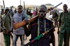  ?? Associated Press ?? ■ Hunters gather Nov. 25, 2014, during a meeting in Yolo, Nigeria. Thousands of Nigerian hunters, armed with charmed amulets and intimate knowledge of harsh terrain, are preparing an offensive against the Boko Haram extremists who have ravaged the northeast for a decade, calling it “high time” they help soldiers end the deadly insurgency.