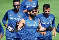  ?? AFP ?? Virat Kohli and teammates attend a training session. —