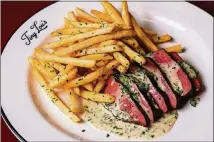  ?? CONTRIBUTE­D BY HENRI HOLLIS ?? The steak frites dish at Tiny Lou’s is as classic as it gets.