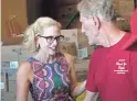  ?? CARLY HENRY/ THE REPUBLIC ?? Kyrsten Sinema helps prepare snack packs with veteran Terry Araman at Desert Mission Food Bank on Friday.