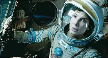  ??  ?? This film image released by Warner Bros. Pictures shows Sandra Bullock in a scene from “Gravity.” Topping the box office for the third straight week, the space adventure “Gravity” continues to be the box-office juggernaut of the fall.