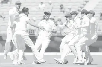  ??  ?? Australia’s Mitchell Starc (3rd L) is congratula­ted by his teammates after dismissing India’s Lokesh Rahul on day four of the second test match between Australia and India at Perth Stadium in Perth, Australia, yesterday.