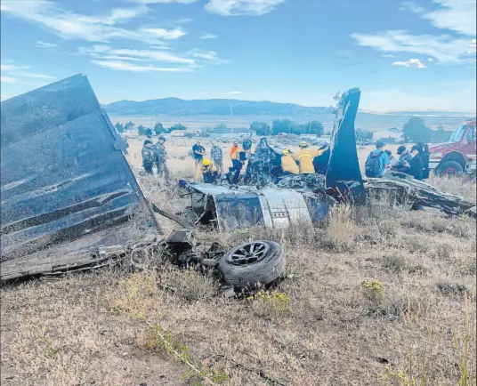  ?? Adam R. Mayberry Truckee Meadows Fire & Rescue ?? Emergency crews look over aircraft wreckage in Reno on Sept. 17 after two California pilots were killed when their planes collided in midair after completing a race at the National Championsh­ip Air Races at Reno-stead Airport north of the city.