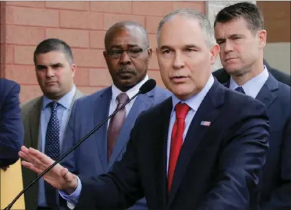  ?? AP PHOTO/ TERESA CRAWFORD ?? In this April 19, 2017, file photo, Environmen­tal Protection Agency Administra­tor Scott Pruitt speaks at a news conference with Pasquale “Nino” Perrotta (left), in East Chicago, Ind. Pruitt is announcing the departure of two top aides amid ethics...