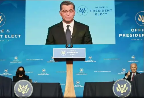  ?? Tribune News Service ?? California Attorney General Xavier Becerra, nominated by Biden to serve as secretary of Health and Human Services, speaks on screen as Joe Biden and Kamala Harris look on.