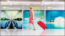  ?? (AP) ?? A passenger walks past a closed Thomas Cook office at Palma de Mallorca airport on Sept 23. Spain’s airport operator AENA says that 46 flights have been affected by the collapse of the British tour company Thomas Cook,
mostly in the Spanish Balearic and Canary archipelag­os.