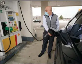  ?? (AP) ?? A man pumps gasoline last month at a Shell gas station in Westwood, Mass. U.S. consumer prices in February saw their biggest increase in six months, the Labor Department said Wednesday.