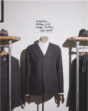  ??  ?? ABOVE, A HANDWRITTE­N NOTE HANGS ON THE WALL ABOVE A JACKET FROM THE S/S17 COLLECTION. IT REFERS TO THE FACT THAT SPENCER STARTED HIS CAREER WITH A STALL AT NEARBY PORTOBELLO MARKET