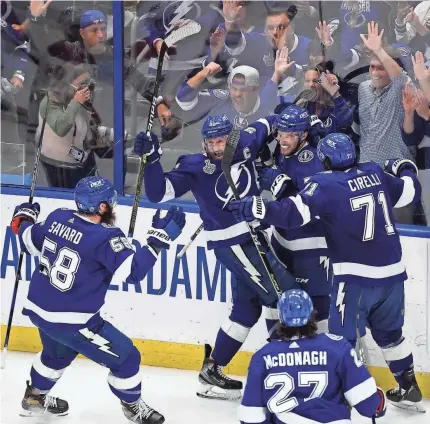  ?? DOUGLAS DEFELICE/USA TODAY SPORTS ?? Left wing Ross Colton, a newcomer to the team this season, celebrates his second-period goal with his Lightning teammates that cemented Tampa Bay’s Stanley Cup repeat.