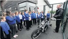  ??  ?? Motorbike maintenanc­e Barry Walker of 35 Cycles talks to P6 kids