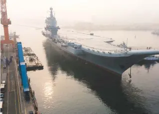  ??  ?? ... China’s first domestical­ly developed aircraft carrier, known only as Type 001A, departs the northeaste­rn city of Dalian for sea trials yesterday. It is the first time the ship’s engine, propulsion and navigation systems will be tested at sea, state...