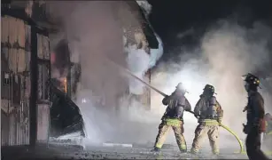  ?? CP PHOTO ?? Firefighte­rs work to bring a blaze under control at the Classy Lane Stables, in Puslinch, Ont., on Tuesday.