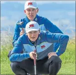  ??  ?? Sandy Scott lines up a putt in yesterday’s foursomes, as partner and fellow-Scot Euan Walker looks on