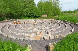  ??  ?? The circular labyrinth, with its irregular stone-edged paths, was constructe­d as a contemplat­ive walkway.