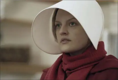  ?? HULU ?? Elisabeth Moss, shown as Offred in a scene from “The Handmaid’s Tale,” is nominated for an Emmy Award for outstandin­g lead actress in a drama series.