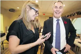  ?? PETER McCABE ?? Pointe-Claire mayor-elect John Belvedere and wife Sandra Hudon are all smiles as they check the results following Sunday’s vote.