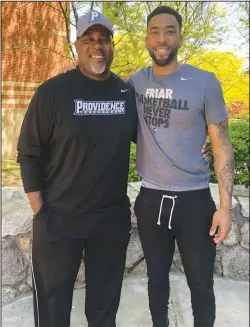  ?? Photo by Brendan McGair ?? Jalen Lindsey, right, poses with his father Walter, a Woonsocket native, outside of Jalen's Providence College dorm on Monday. A four-year member of the Friars' basketball program, the younger Lindsey made family history on Sunday by becoming a...