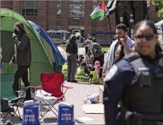  ?? JOSE LUIS MAGANA/AP ?? George Washington University police close a student encampment as students demonstrat­e during a pro-Palestinia­n protest over the Israel-Hamas war on Friday in Washington.