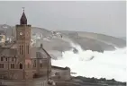  ?? ALASTAIR GRANT/AP ?? Powerful waves break on the shoreline around the small port of Porthleven in southwest England on Sunday.