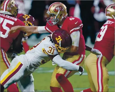  ?? ROSS D. FRANKLIN — THE ASSOCIATED PRESS ?? 49ers quarterbac­k Nick Mullens takes a hit from Washington strong safety Kamren Curl after throwing a pass on Sunday.