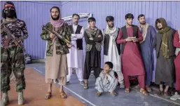  ?? ?? Taliban fighters stand as youths show their skills during an event organised for the visit of Talibans director of physical education and sports Bashir Ahmad Rustamzai (not pictured) in Kabul. AFP