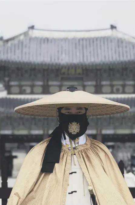  ??  ?? 2 Face masks are widely used across the world as part of the response to Covid. Here, an Imperial guard at Gyeongbok Palace in Seoul, South Korea, wears one on duty