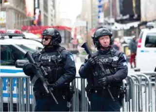 ??  ?? Police officers stand guard in New York. (File photo/AFP)