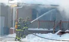  ?? HARRY ROSETTANI/ SPECIAL TO THE TRIBUNE ?? Wainfleet firefighte­rs battle a house fire at 11645 Highway 3 on Wednesday, where a fire caused by a malfunctio­ning electrical appliance caused an estimated $ 200,000 in damage.