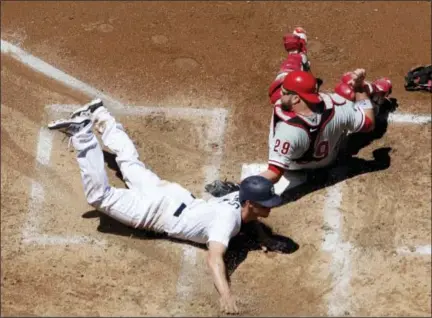  ?? GREGORY BULL — THE ASSOCIATED PRESS ?? The San Diego Padres’ Wil Myers slides into home safe on a steal attempt ahead of the tag by Philadelph­ia Phillies catcher Cameron Rupp during the fourth inning of Wednesday’s game in San Diego.