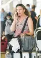  ?? MARTA LAVANDIER/AP ?? A traveler waits to be picked up Saturday at Miami Internatio­nal Airport.