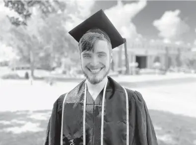  ?? COURTESY PHOTO ?? Jonah Yonker standing in his cap and gown in front of Millican Hall at UCF. Yonker graduated in May 2020.