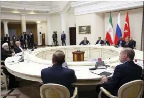  ?? KAYHAN OZER — POOL VIA AP ?? Turkey’s President Recep Tayyip Erdogan, right, Russia’s President Vladimir Putin, rearcentre, and Iran’s President Hassan Rouhani, left, sit during a meeting Wednesday in Sochi, Russia.