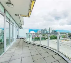  ??  ?? Unit 1105 in the Sails developmen­t at 1661 Ontario St. in southeast False Creek has a luxe kitchen, a solarium and a 245-square-foot balcony.
