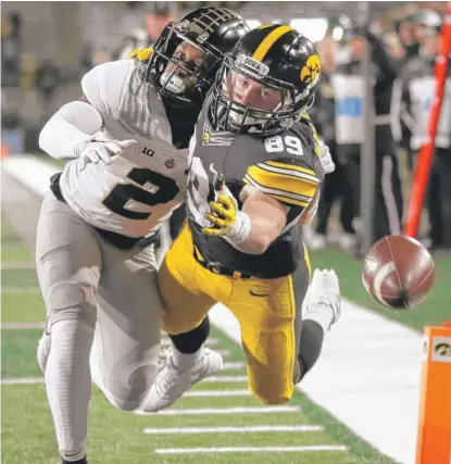  ?? | AP ?? Purdue cornerback Da’Wan Hunte ( left) breaks up a pass intended for Iowa receiver Matt VandeBerg in the second half.