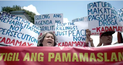  ??  ?? ACTIVISTS HOLD a protest in front of the PNP headquarte­rs, condemning what they call extra-judicial killings.