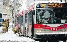  ?? LEAH HENNEL ?? Firefighte­rs help get a stuck bus moving at the intersecti­on of 4th Street and 12th Avenue SW on Tuesday.