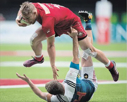  ?? CANADIAN PRESS FILE PHOTO ?? Canada’s Harry Jones, top, collides with France’s Thibauld Mazzoleni while running with the ball in World Rugby Sevens Series action March 11.