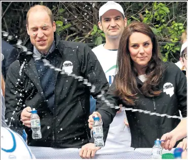  ??  ?? William and Kate fi nd themselves in the fi ring line as they hand out water yesterday