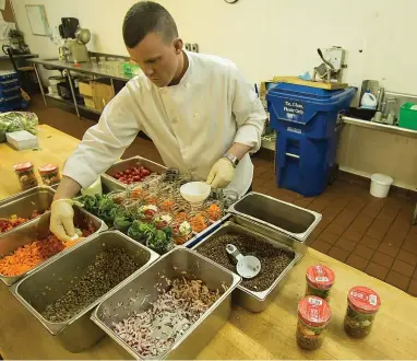  ??  ?? Head cook John Steimann leads the food production process for Meal in a Jar.