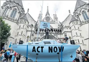  ??  ?? Extinction Rebellion activists stage a protest in support of ecocide law at the Royal Courts of Justice in London in July 2019