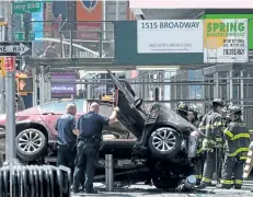  ?? DREW ANGERER/GETTY IMAGES ?? A wrecked car is seen in New York’s Times Square on Thursday after a man drove onto the sidewalk, killing one person and injuring 20 others.