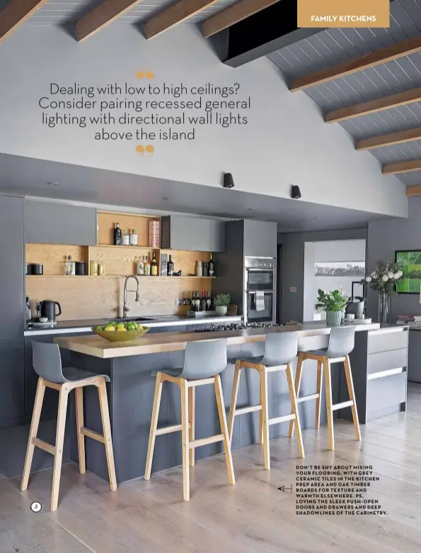  ??  ?? DON’T BE SHY ABOUT MIXING YOUR FLOORING WITH GREY CERAMIC TILES IN THE KITCHEN PREP AREA AND OAK TIMBER BOARDS FOR TEXTURE AND WARMTH ELSEWHERE PS LOVING THE SLEEK PUSH OPEN DOORS AND DRAWERS AND DEEP SHADOWLINE­S OF THE CABINETRY